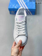 Top view showing the white laces, perforated side panels, rounded toe, and pink tongue label.