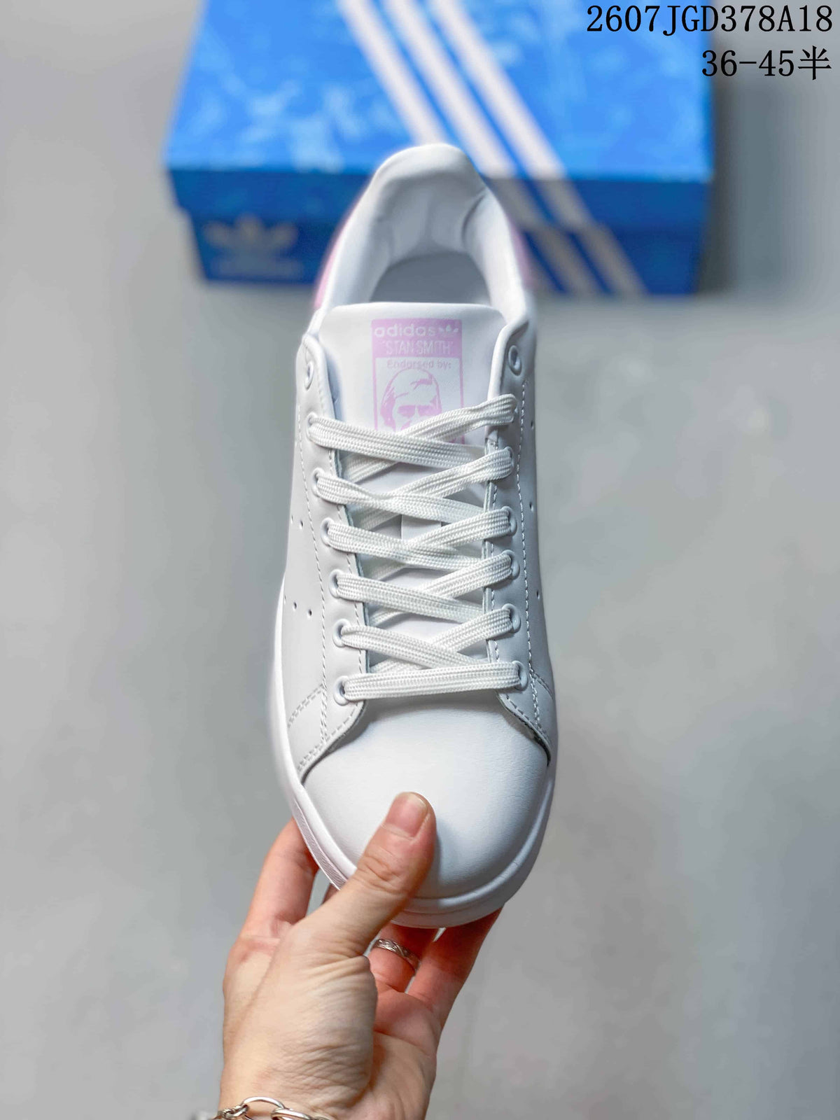 Top view showing the white laces, perforated side panels, rounded toe, and pink tongue label.