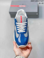 Top view of the blue and white lace-up sneaker with red Prada tongue detailing.