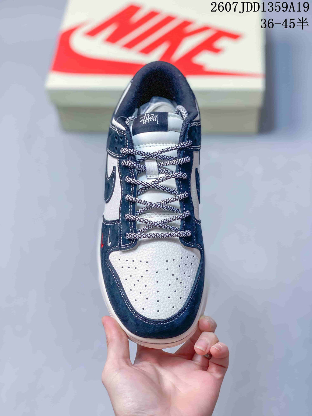 Top view showing the perforated white toe box, patterned laces, and navy overlays.