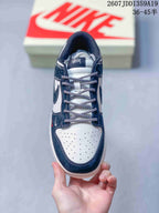Top view showing the perforated white toe box, patterned laces, and navy overlays.
