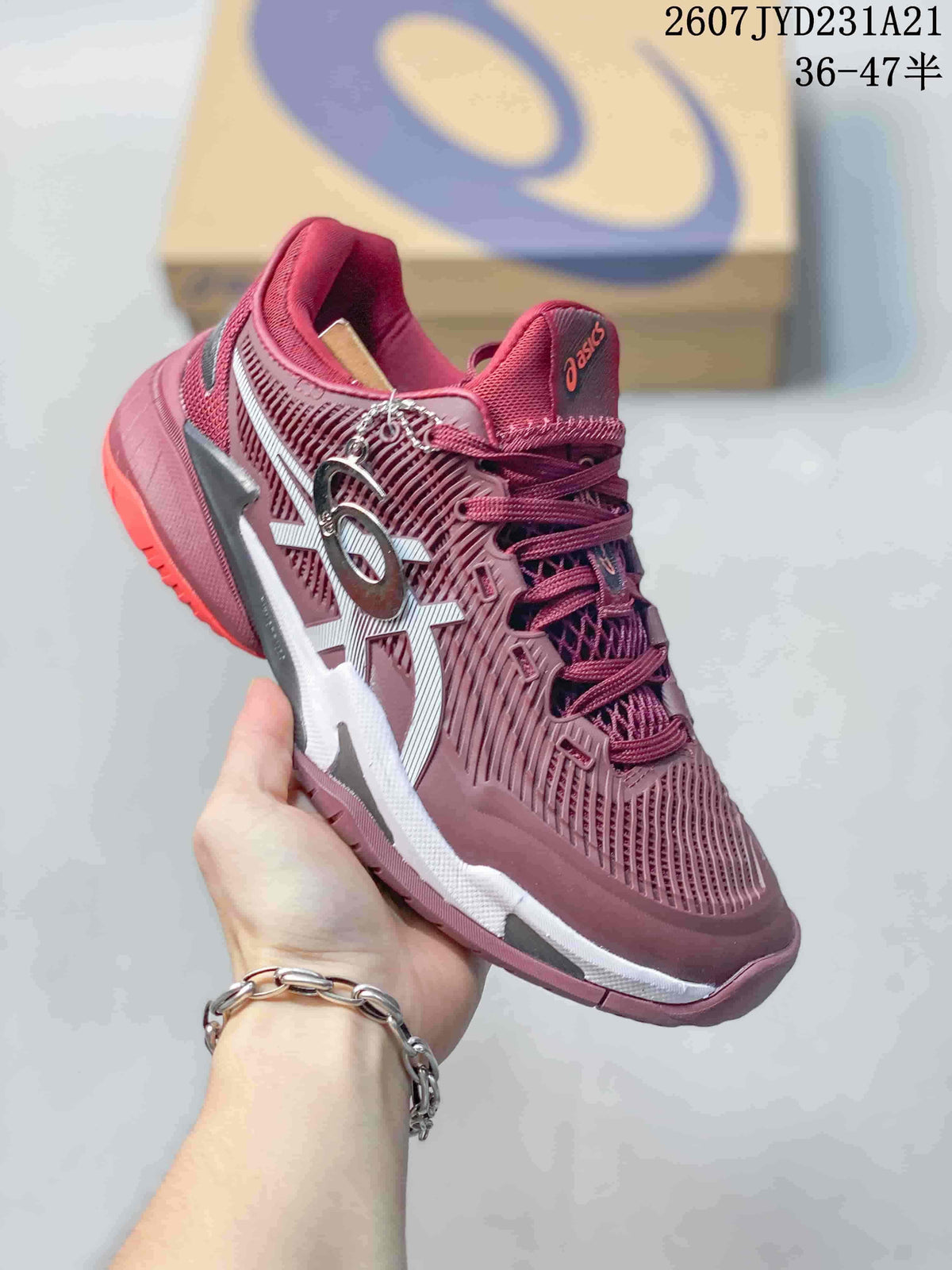 Angled side view of the burgundy ASICS tennis shoe showing the white side logo, layered midsole, and red outsole accents.