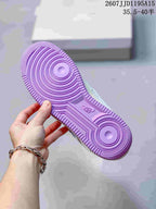 Close-up of the sneaker outsole showing a purple circular traction pattern.