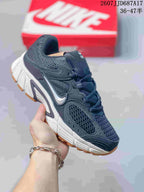 Dark navy and black Nike V5 RNR sneaker with a white midsole and gum-colored outsole accents.