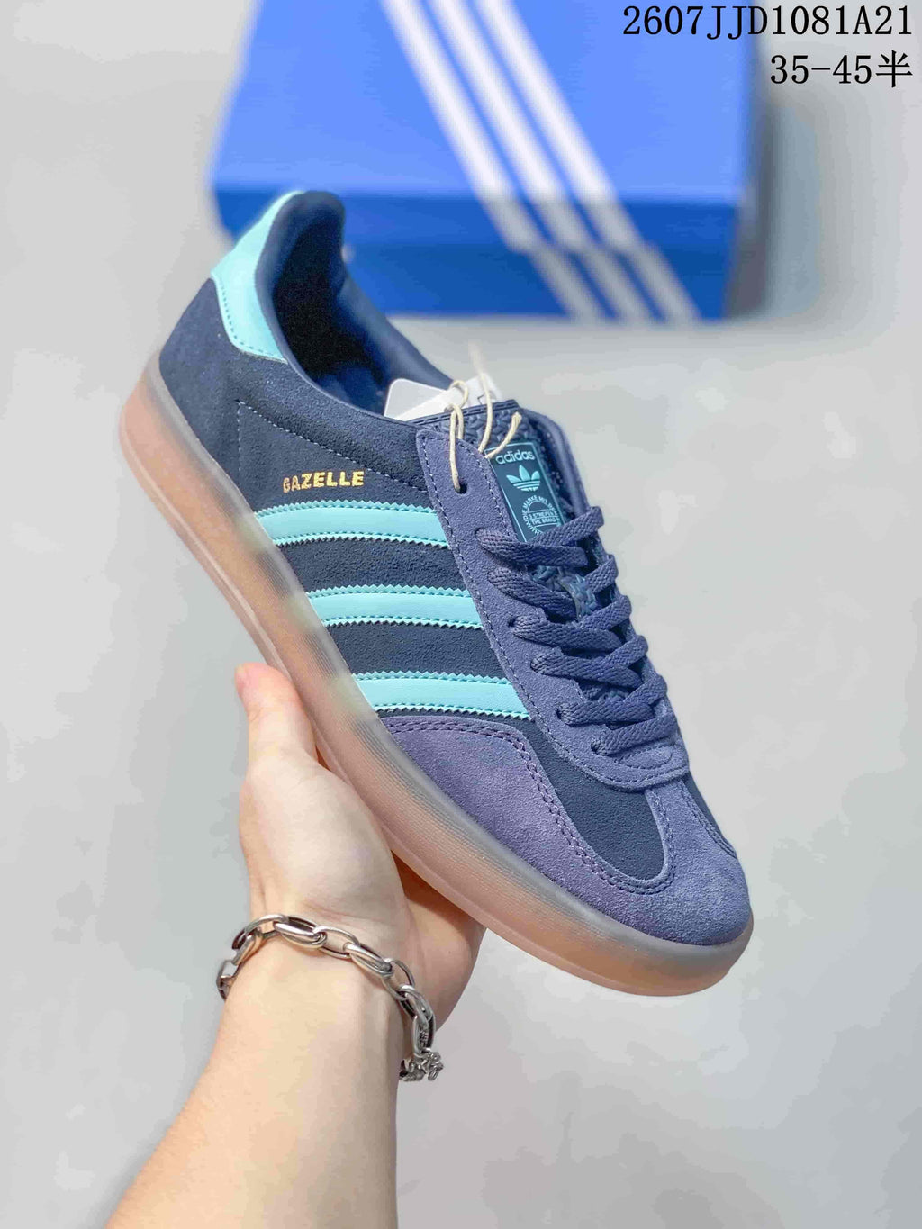 Angled side view highlighting the Gazelle lettering, turquoise stripes, navy upper, and gum-colored sole.