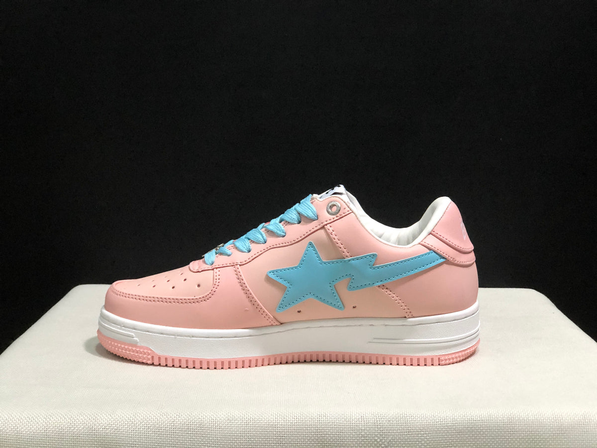 Side profile of one pink Bape Sta sneaker showing the large light-blue star side panel and layered white midsole.