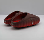 Rear three-quarter view showing the open heel design, side swoosh, and heel plaques.