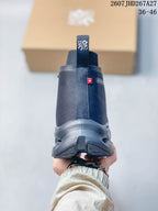 Rear view of a dark gray high-top sneaker showing the heel pull tab, ankle collar, small red side detail and sculpted outsole.