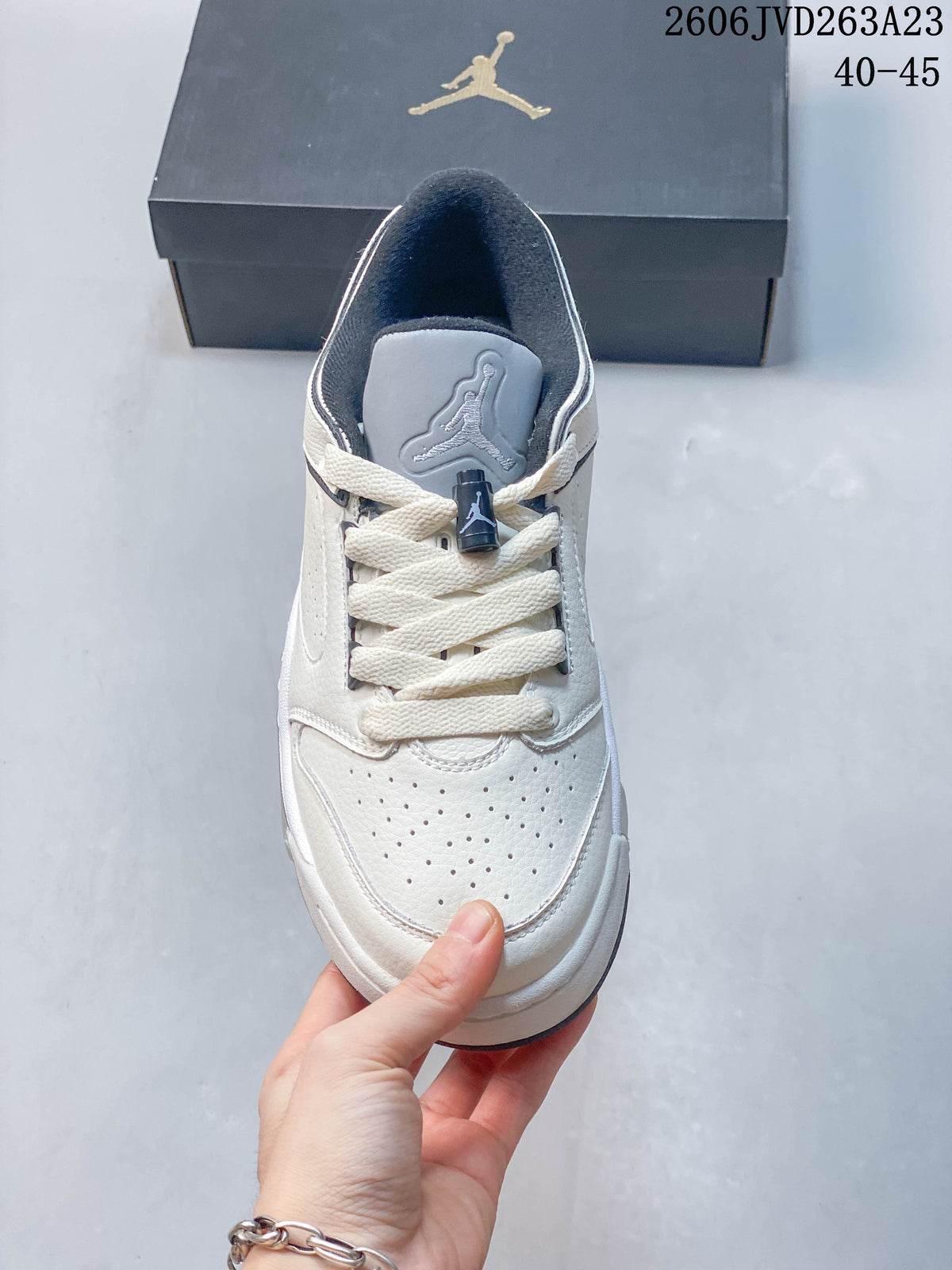 Top view of the Jordan Sixty Plus Low showing perforations, laces, and a gray tongue.