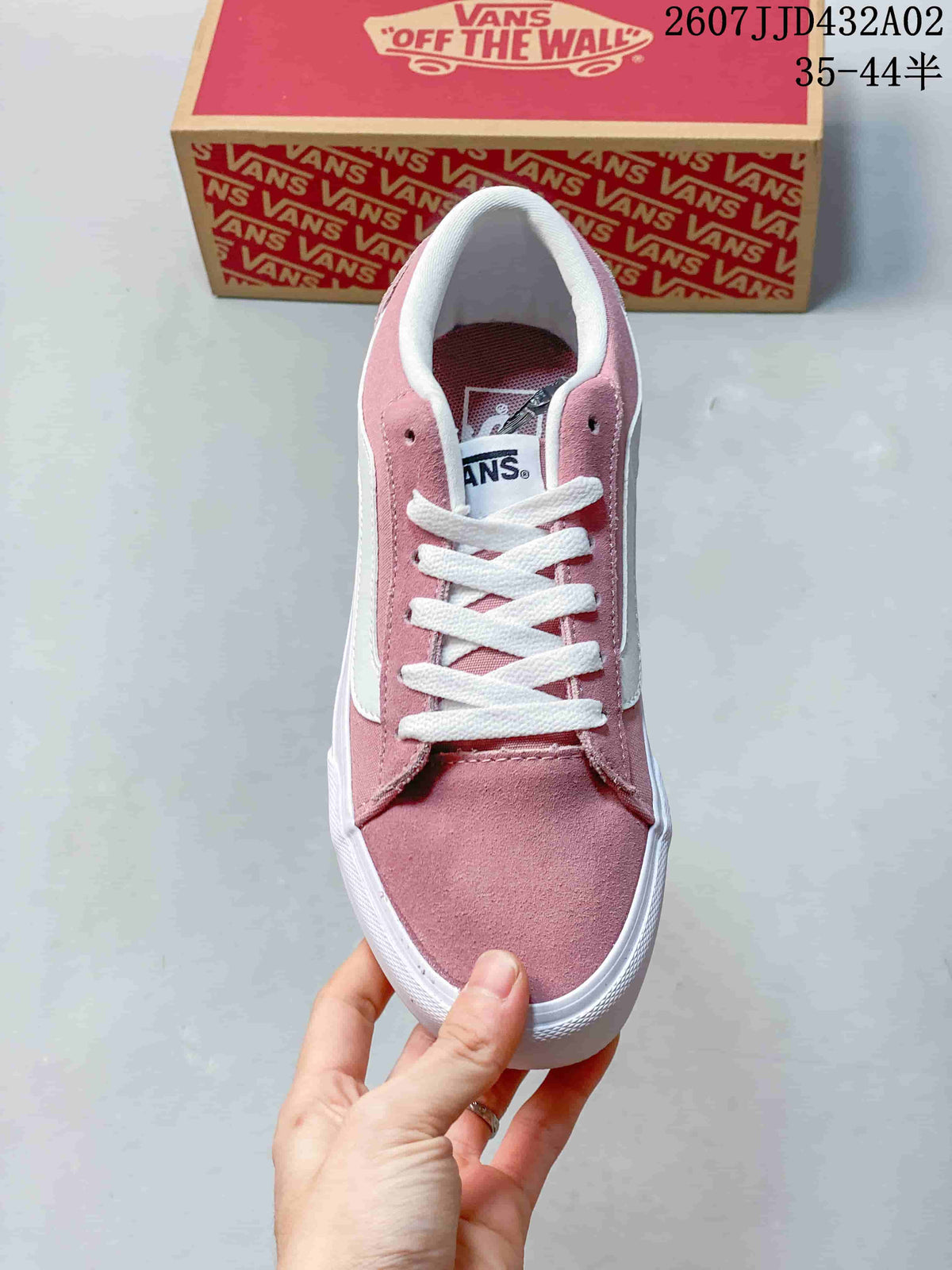 Top view of a pink lace-up sneaker with white laces