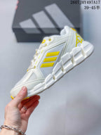 Side profile highlighting the mesh-style upper, yellow three-stripe detailing, TPU support elements, and segmented sole.