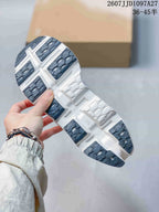 Underside view of the sneaker showing segmented dark gray and white outsole sections.