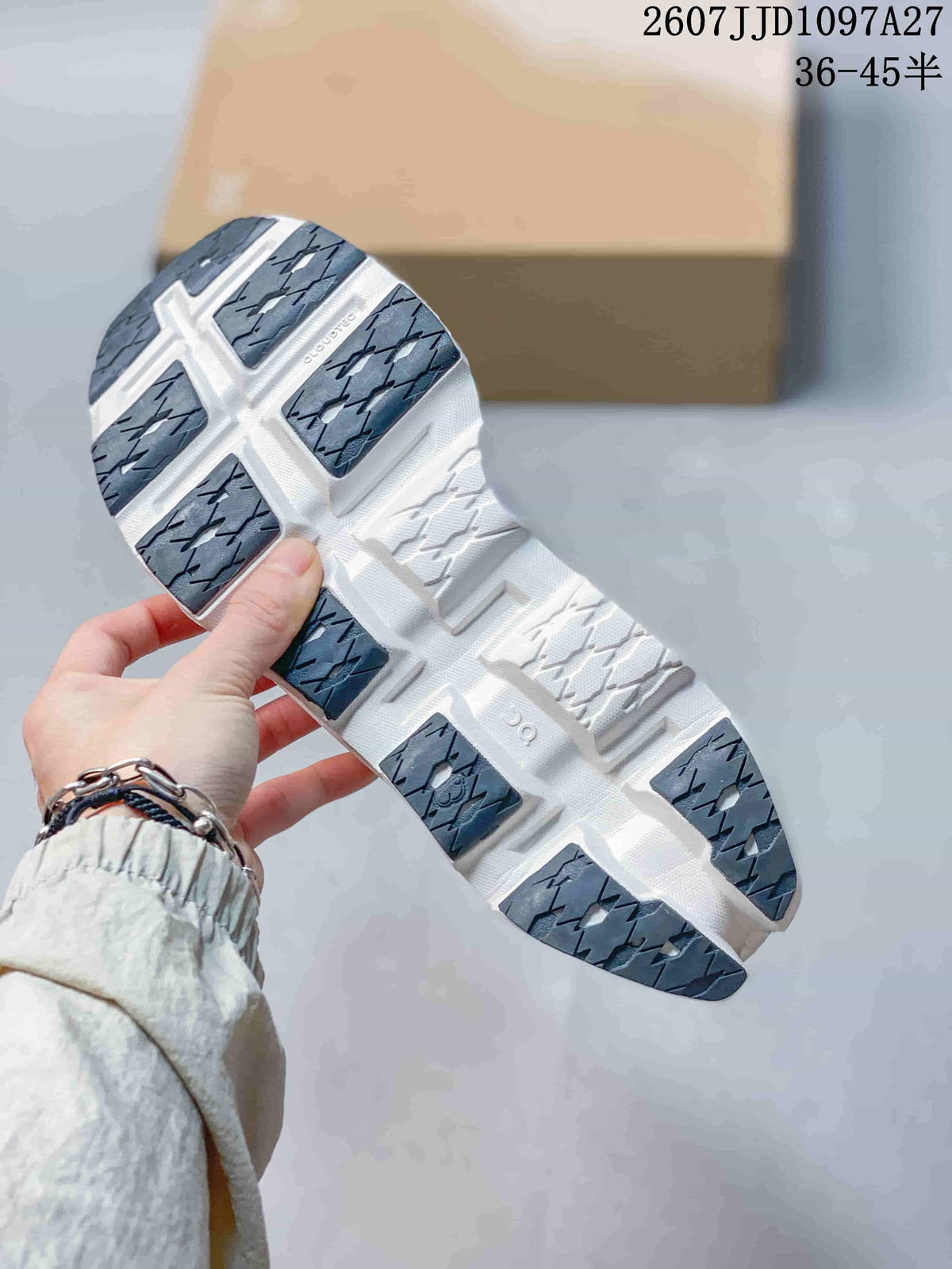 Underside view of the sneaker showing segmented dark gray and white outsole sections.