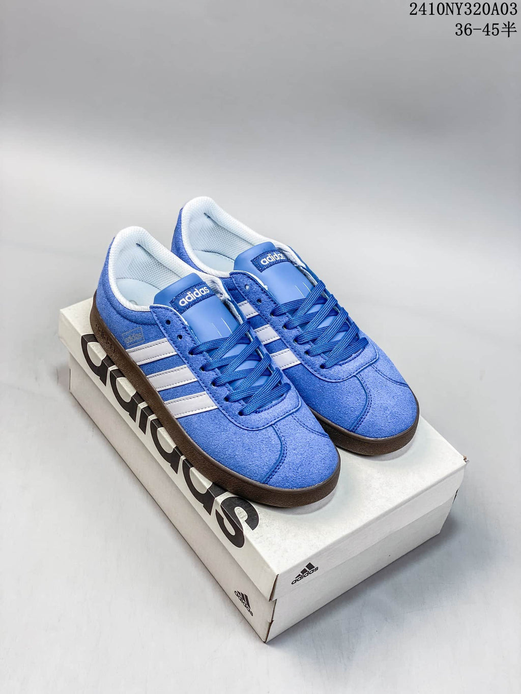 Pair of blue Adidas sneakers with white side stripes displayed on an Adidas shoebox.