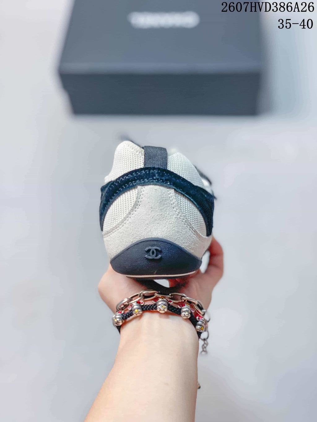 Rear view of the sneaker showing the contrasting heel panels and Chanel logo detail.