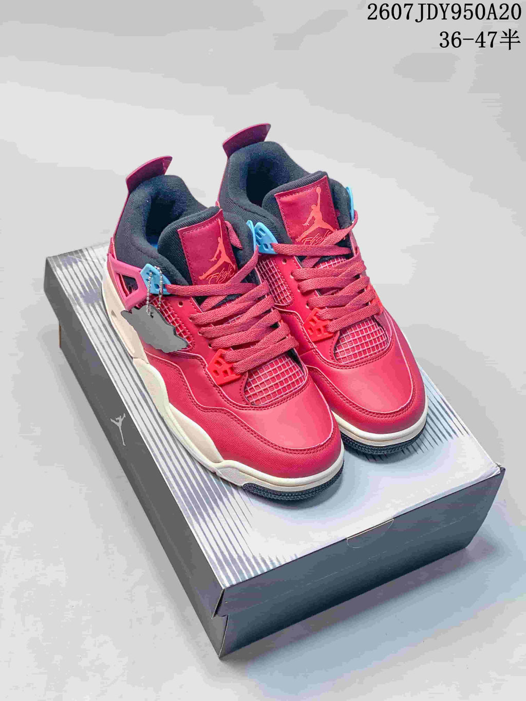 Pair of pink, black, and white Jordan Air Jordan 4 Retro-style sneakers displayed on a shoebox; overlay text shows style code 2607JDY950A20 and size range 36–47.5.