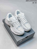 White and grey New Balance 509 sneakers displayed on a New Balance shoebox; style code 2607JJD292A02 and size range 36–45 are visible above the shoes.