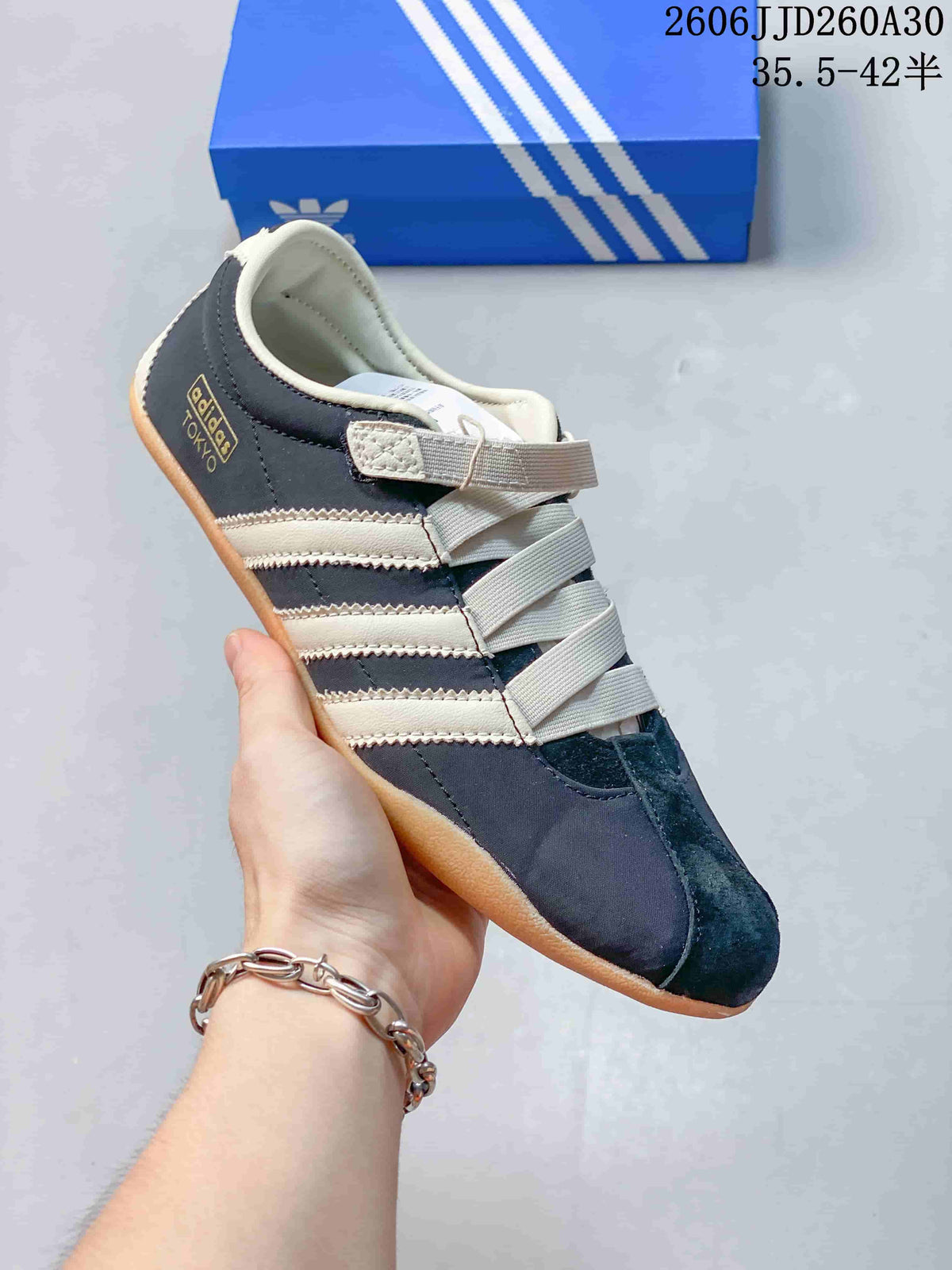 Side view of a navy and cream Tokyo MJ sneaker with three side stripes and strap-and-lace closure.