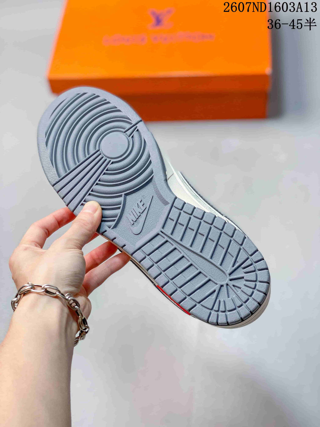 Close view of the grey rubber outsole showing circular traction rings and a Nike mark.