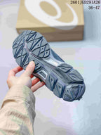 Close view of the patterned outsole on a gray ASICS sneaker.