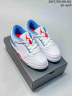 Pair of white Jordan low-top sneakers with blue and red details, shown on a dark shoebox