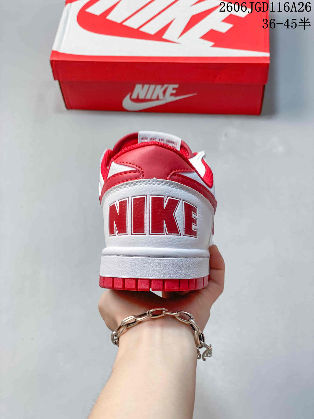 Rear view of the white and red sneaker with Nike lettering on the heel