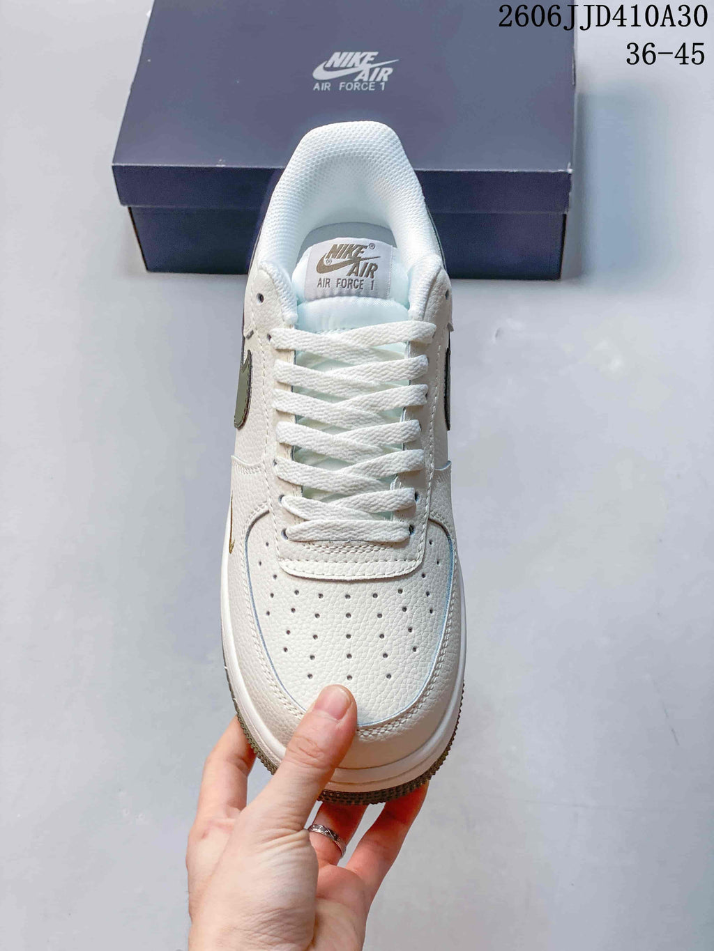 Front view showing the perforated toe, white laces, and tongue label