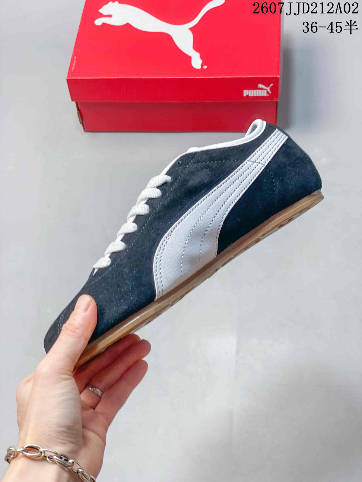 Side profile of the navy PUMA Tackle sneaker with white Formstrip and gum-colored outsole