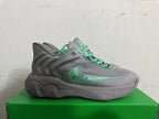 Side profile of a grey Nike KD 4 shoe with a green Swoosh
