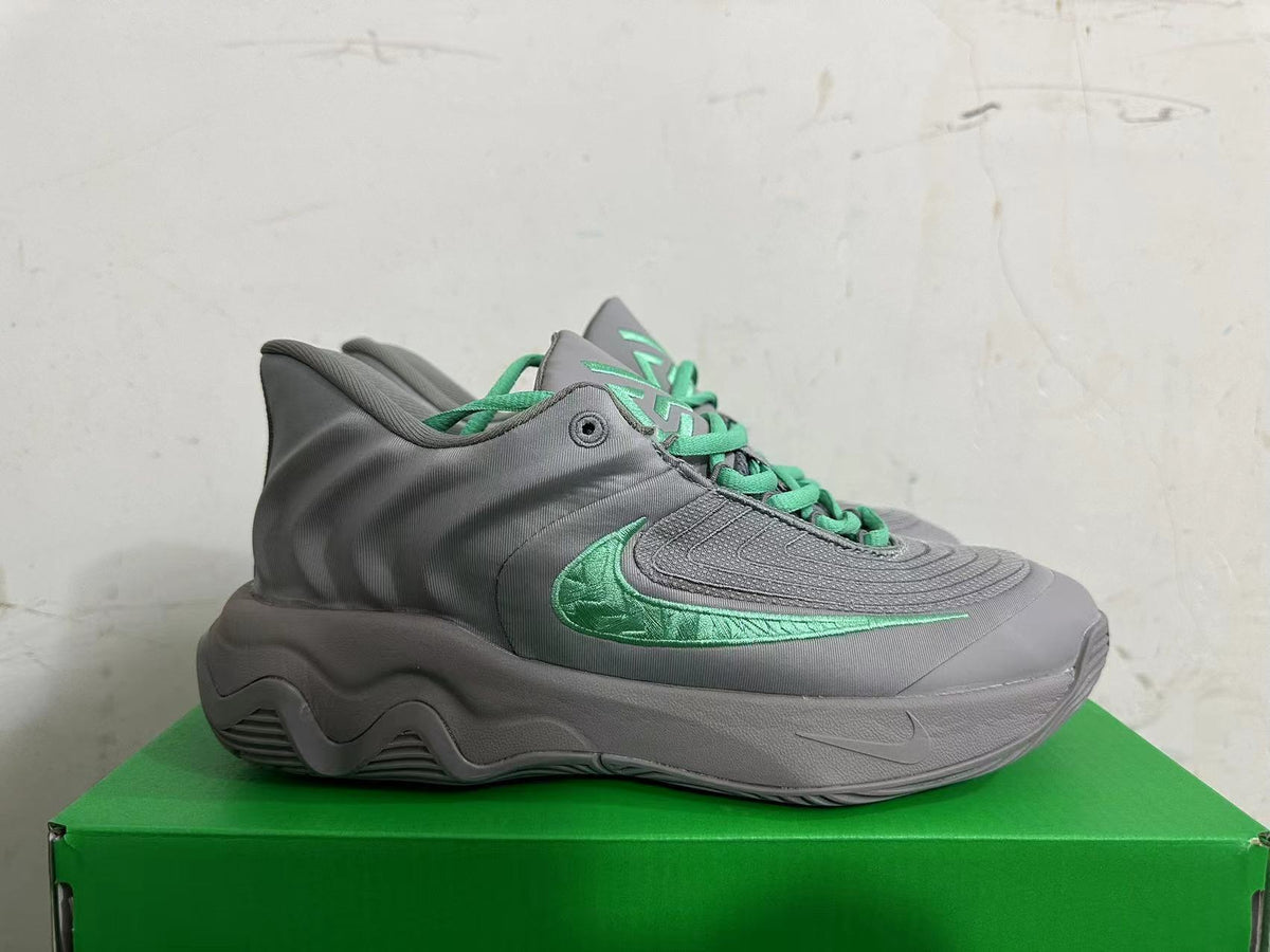 Side profile of a grey Nike KD 4 shoe with a green Swoosh