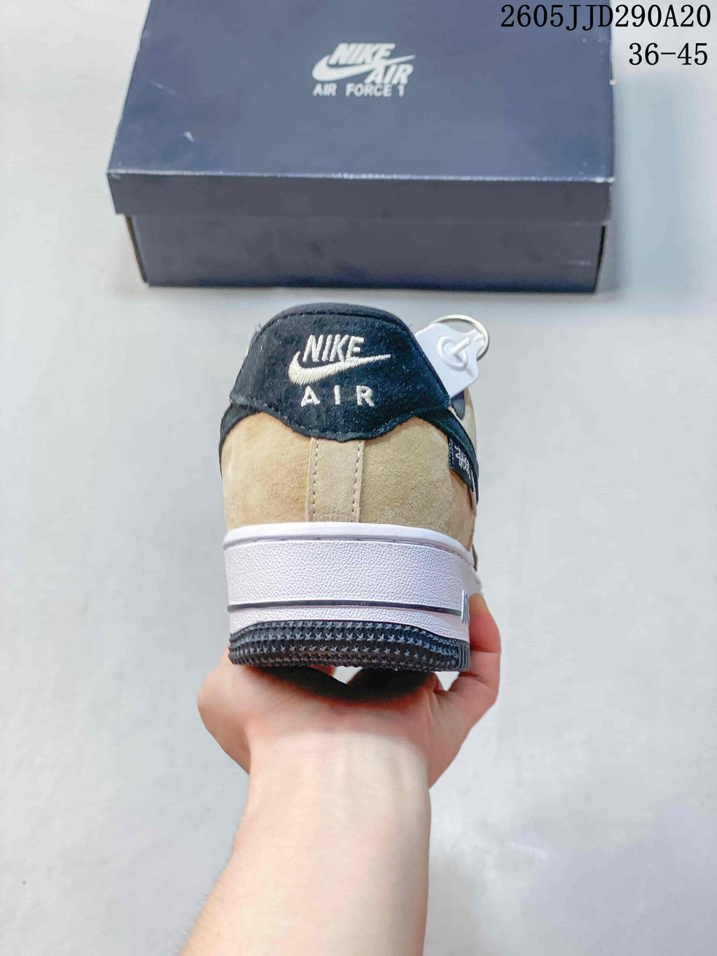 Rear view of a Nike Air Force 1 Shadow sneaker showing the black-and-beige heel, white midsole, and black outsole.