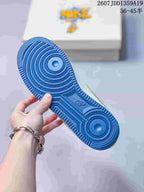 Close-up of the blue rubber outsole with concentric circular traction patterns and Nike branding.