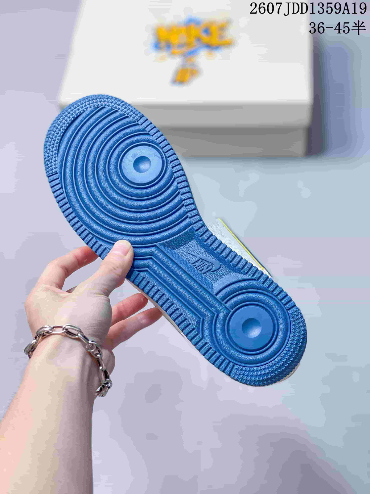 Close-up of the blue rubber outsole with concentric circular traction patterns and Nike branding.