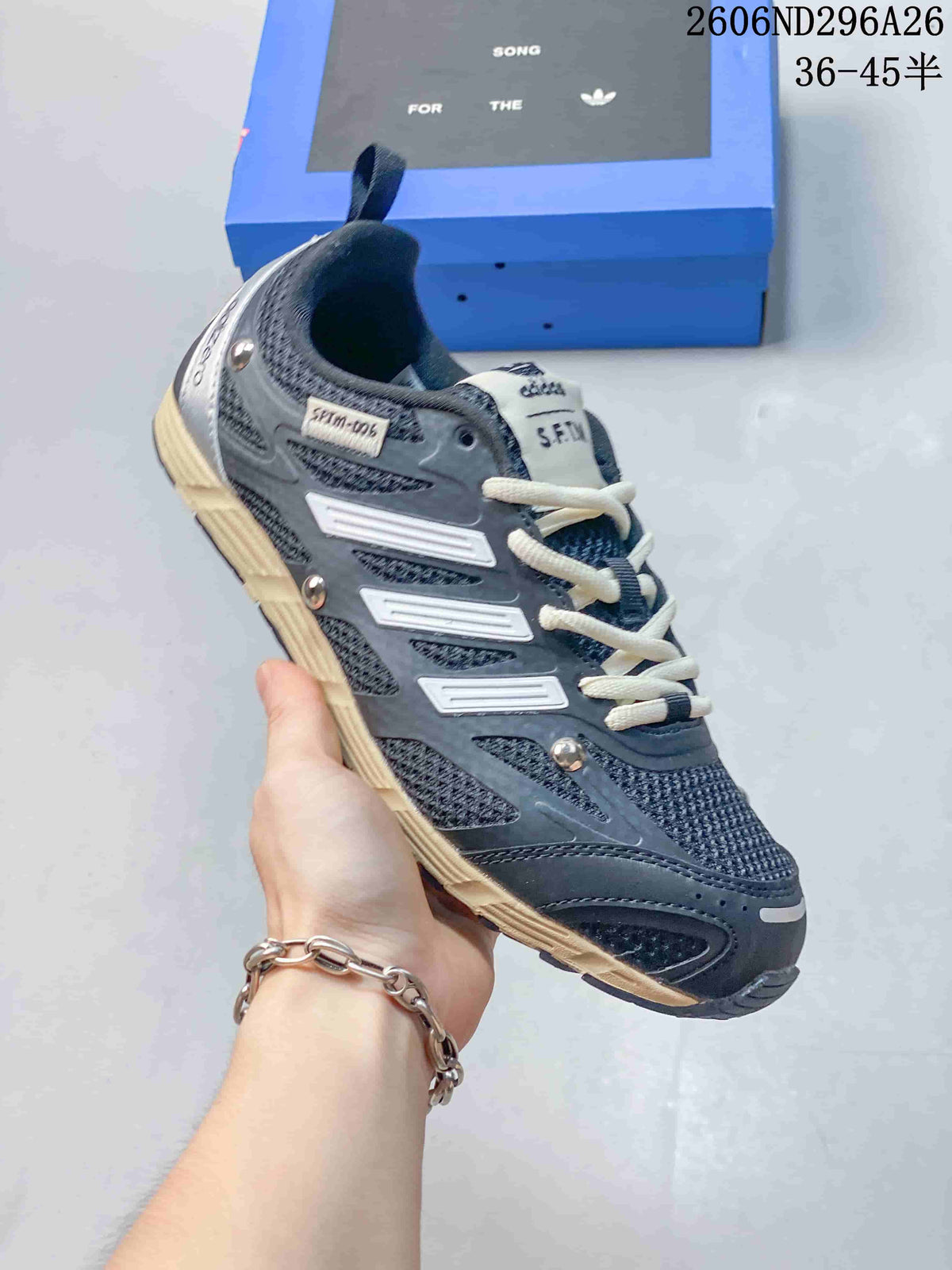 Dark blue-gray Adidas SFTM-006 low-top sneaker with light laces and a cream-colored outsole.