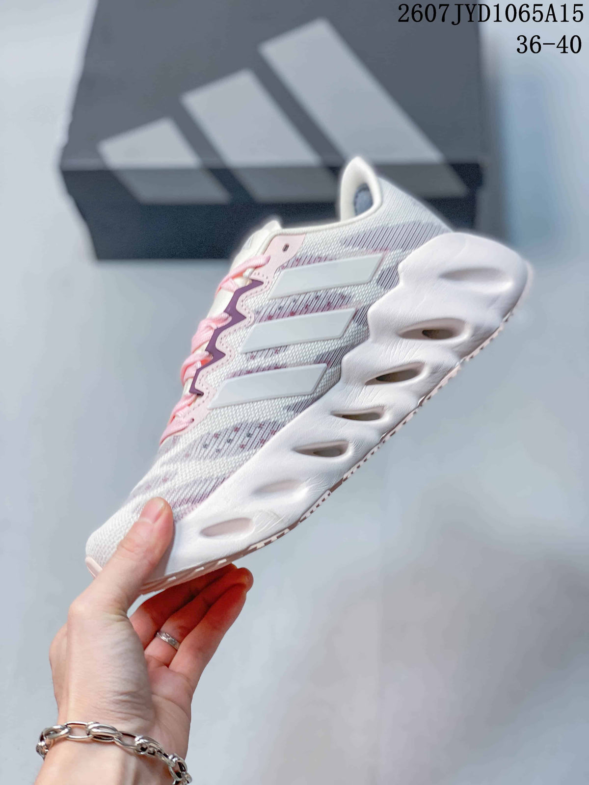 Side profile highlighting the layered side panels, textured upper, and sculpted white sole.