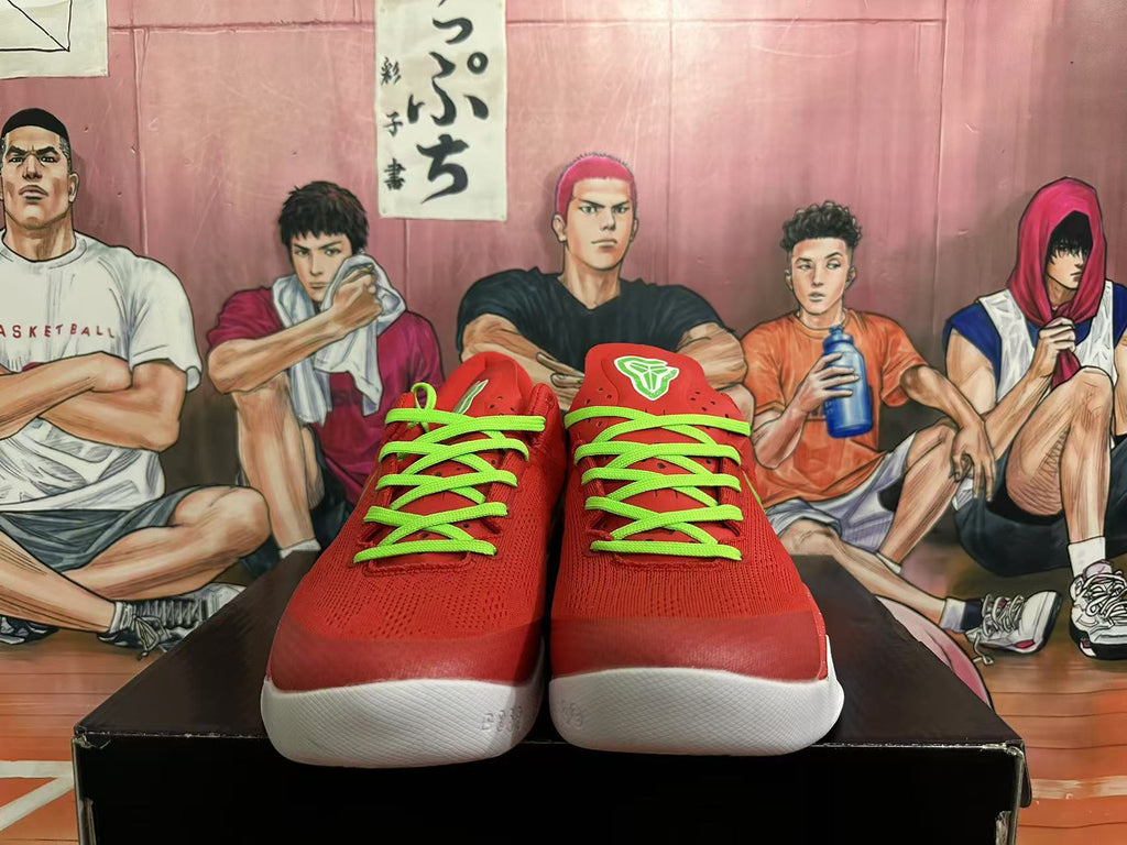 Front view of red Nike Kobe basketball shoes with bright green laces and white outsoles