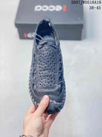 Top view of the black sneaker showing the perforated vamp, lace-up closure and padded tongue.