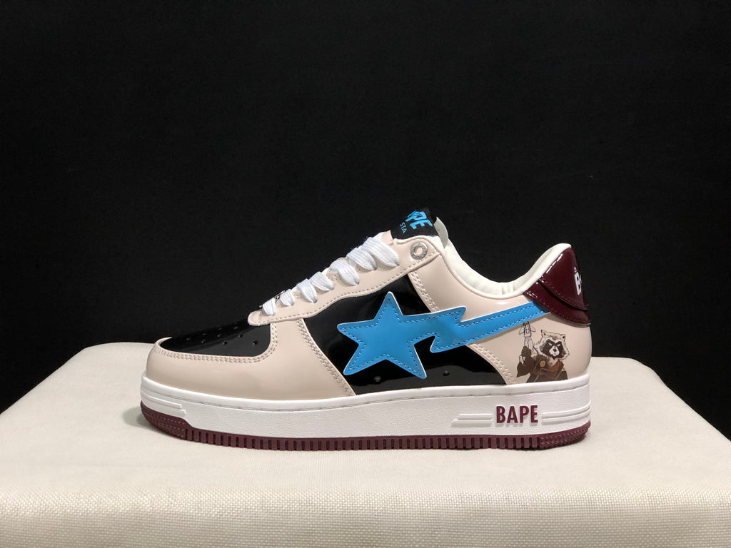 Side view showing the blue star emblem, black side panel, cream upper, burgundy heel detail, and BAPE branding on the midsole.