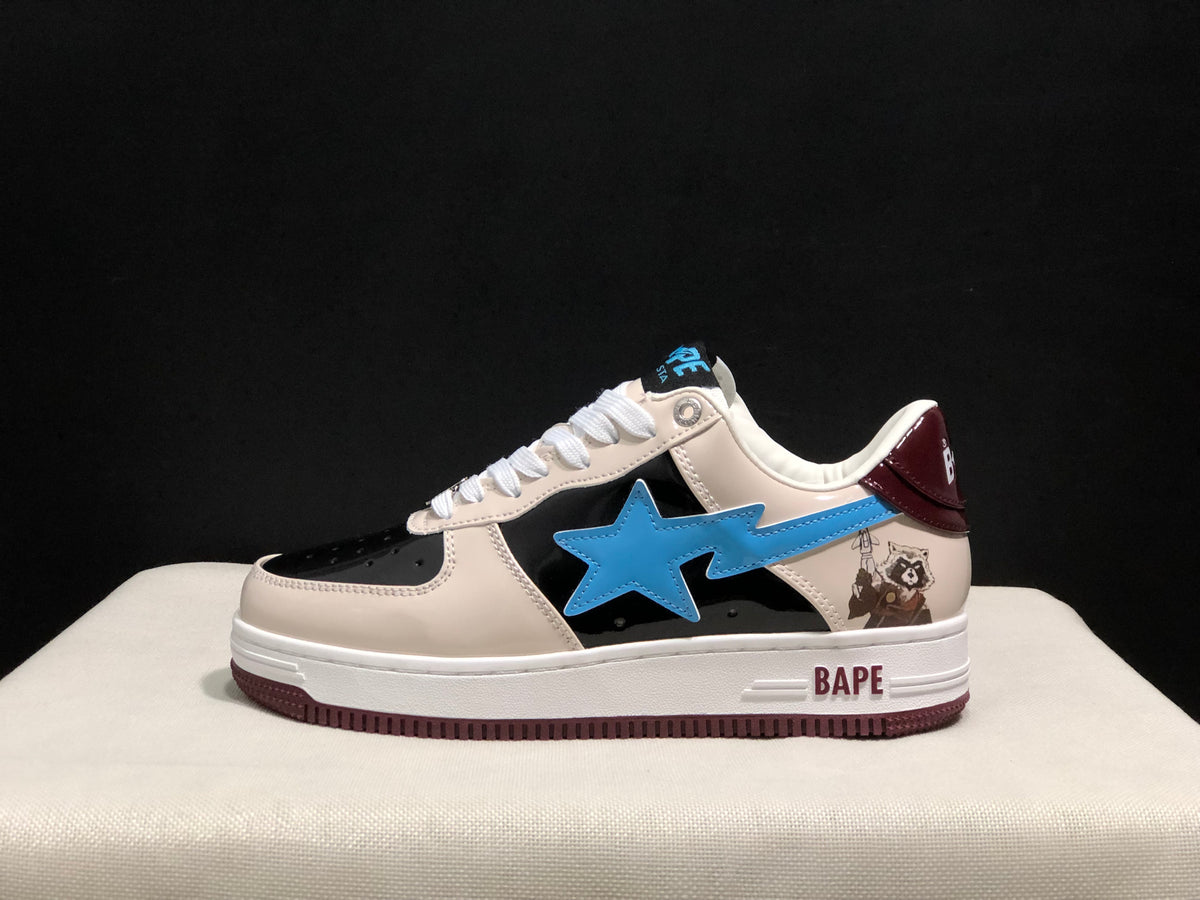 Side view showing the blue star emblem, black side panel, cream upper, burgundy heel detail, and BAPE branding on the midsole.