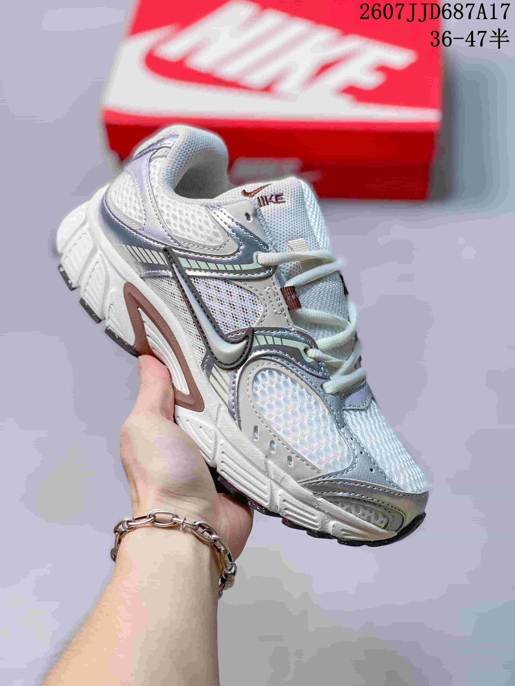 White Nike V5 RNR sneaker with silver-gray overlays and a reflective-looking forefoot panel.