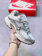 White Nike V5 RNR sneaker with silver-gray overlays and a reflective-looking forefoot panel.
