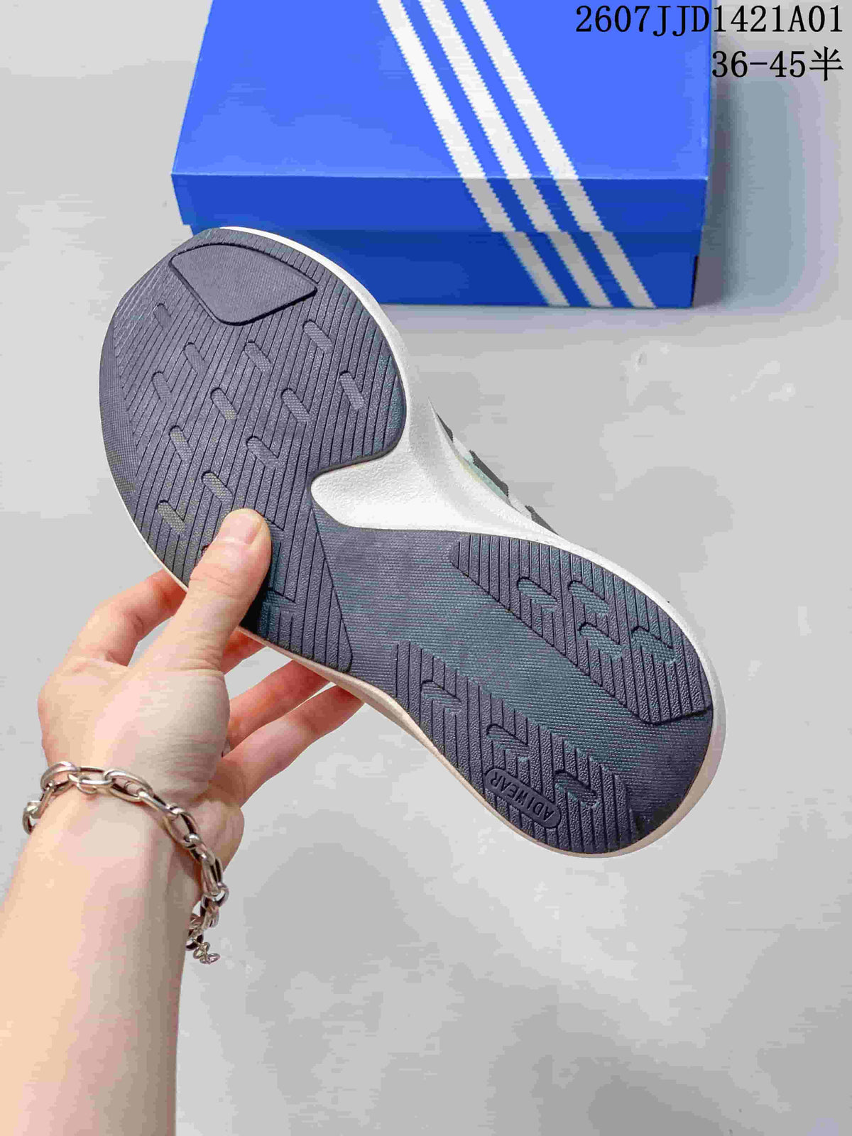 Close-up of the dark patterned outsole on an Adidas Adizero SL 72 Pro sneaker