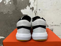 Rear view of white and black Nike Hyperquick low-top training shoes with gum-colored outsoles