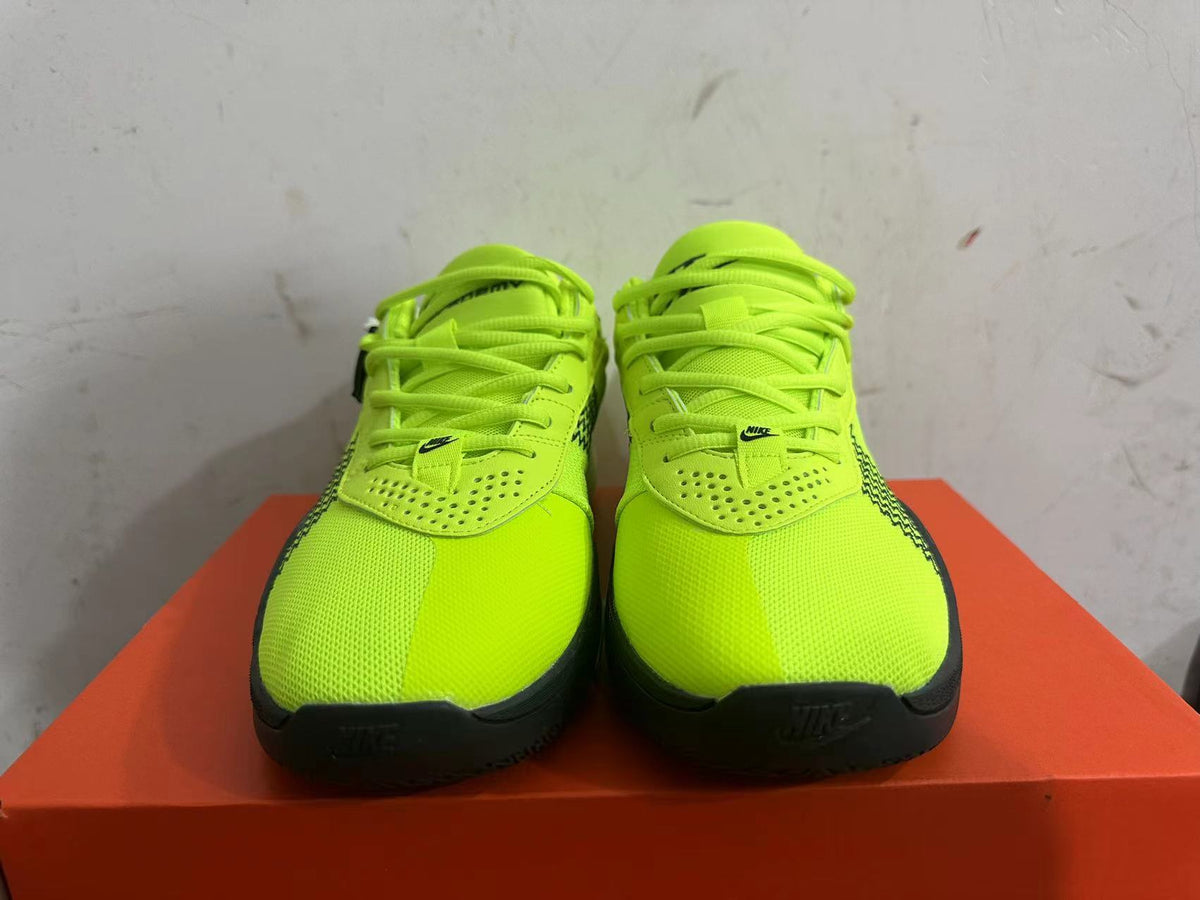Front view of bright green Nike basketball shoes with black toe outsoles and lace-up closures