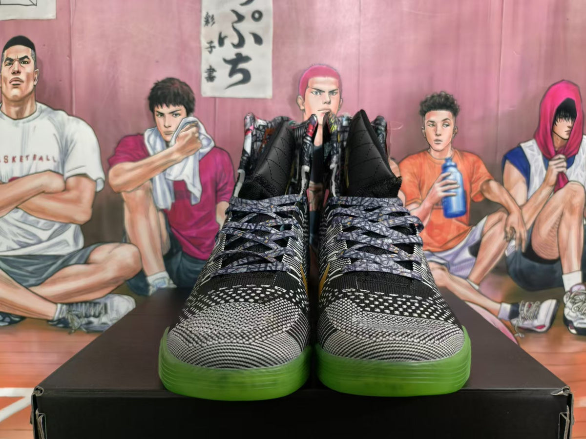 Front view of black and gray patterned high-top basketball shoes with green outsoles