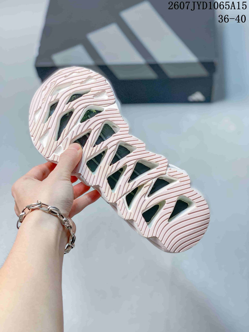 Close view of the patterned outsole showing sculpted channels and multiple open cutout sections.