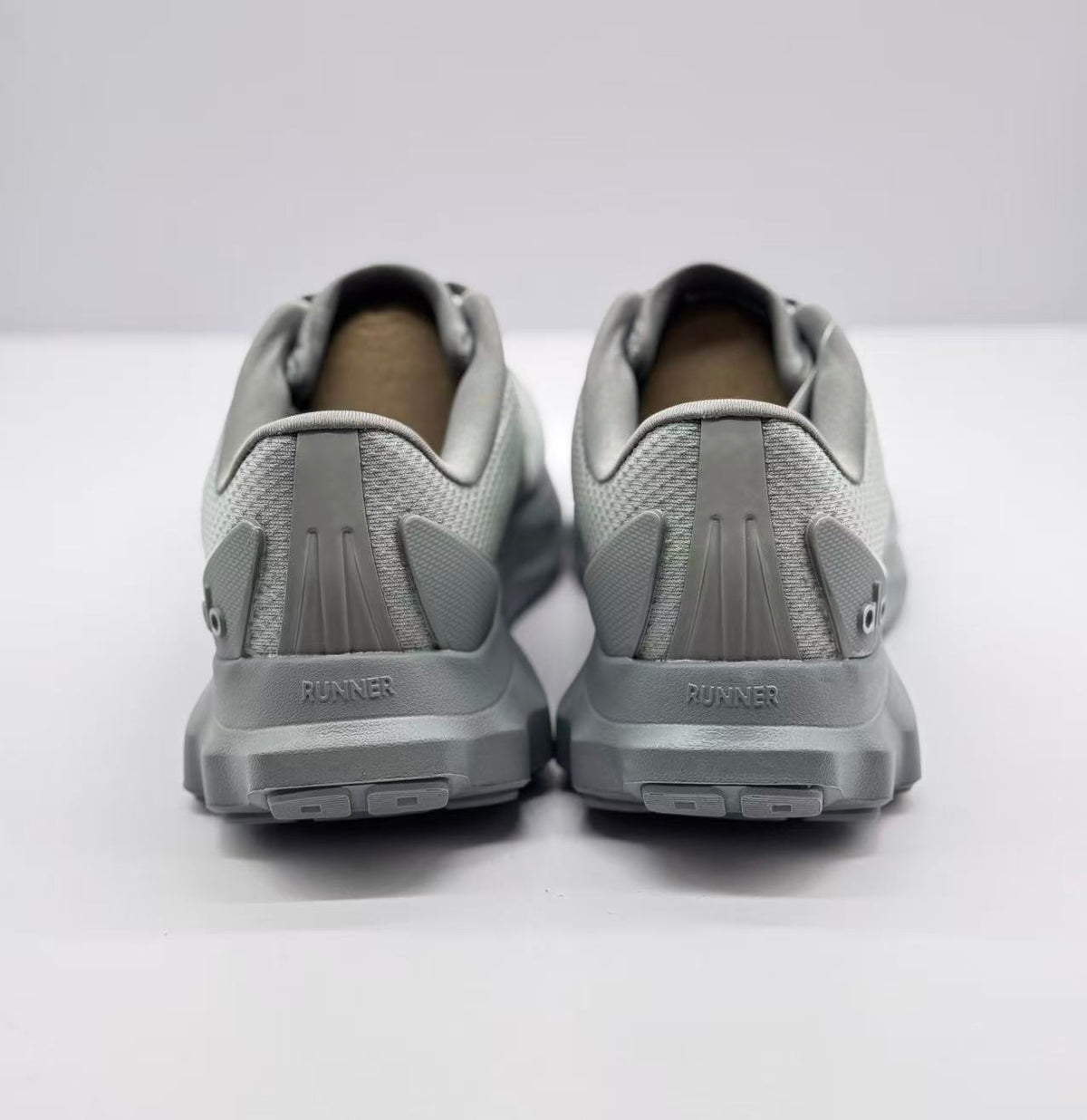 Rear view of the pair showing heel reinforcement and the visible word RUNNER on the midsoles.