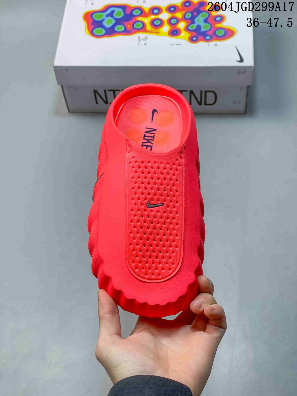 Top view of a red Nike Mind slide showing the perforated footbed area and Nike logo.