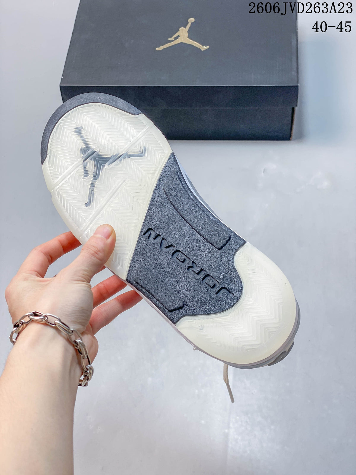 Underside of a Jordan Sixty Plus Low shoe showing a patterned outsole and central midfoot panel.