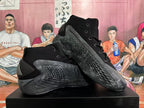 Pair of black and dark gray basketball shoes displayed at an angle.